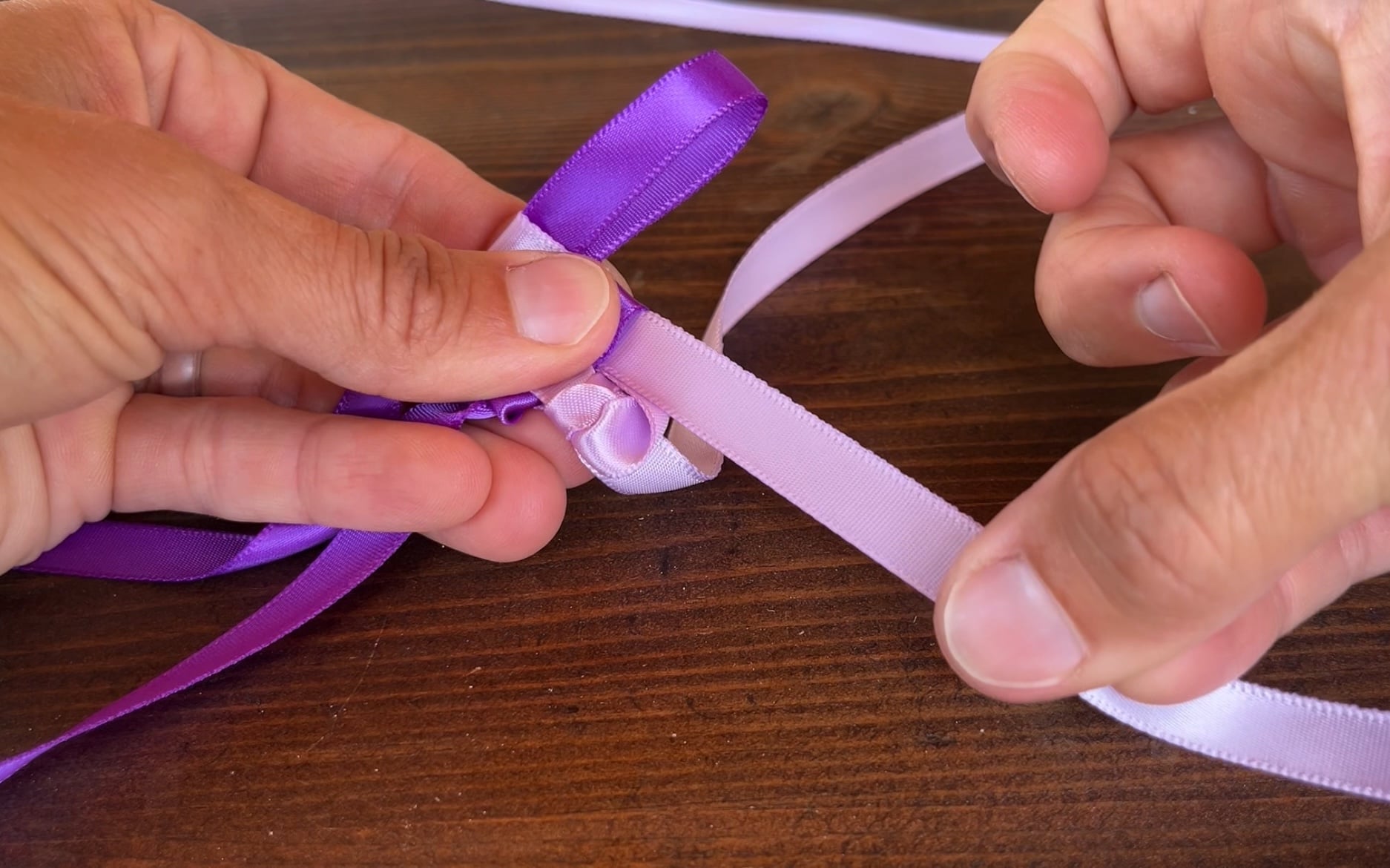 making a dark purple ribbon lei to continue the ribbon lei making process