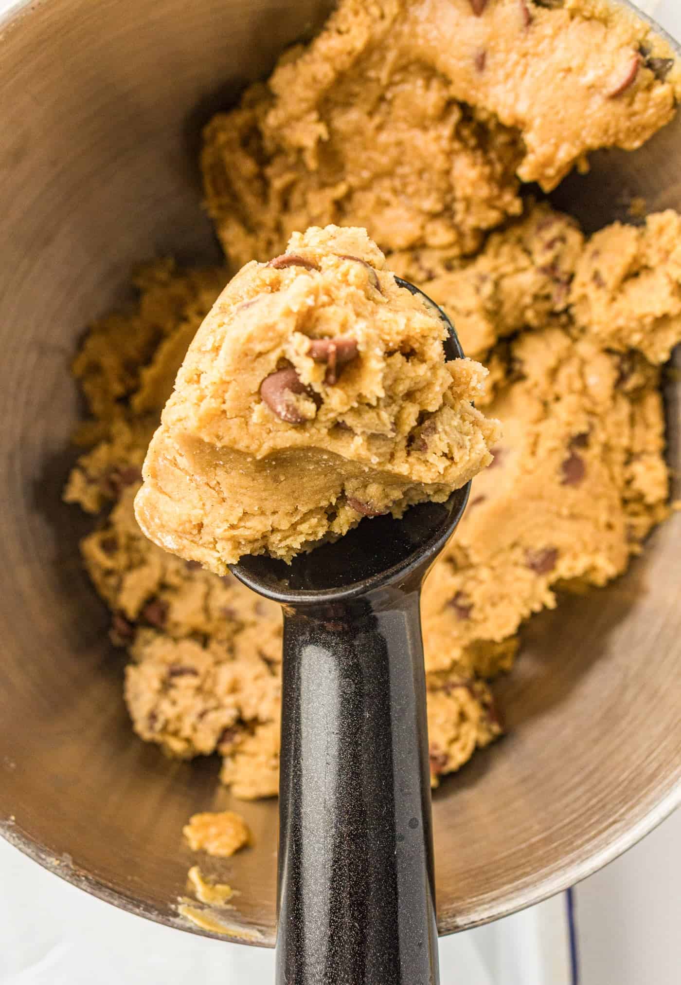 using a scoop for chocolate chip cookie dough