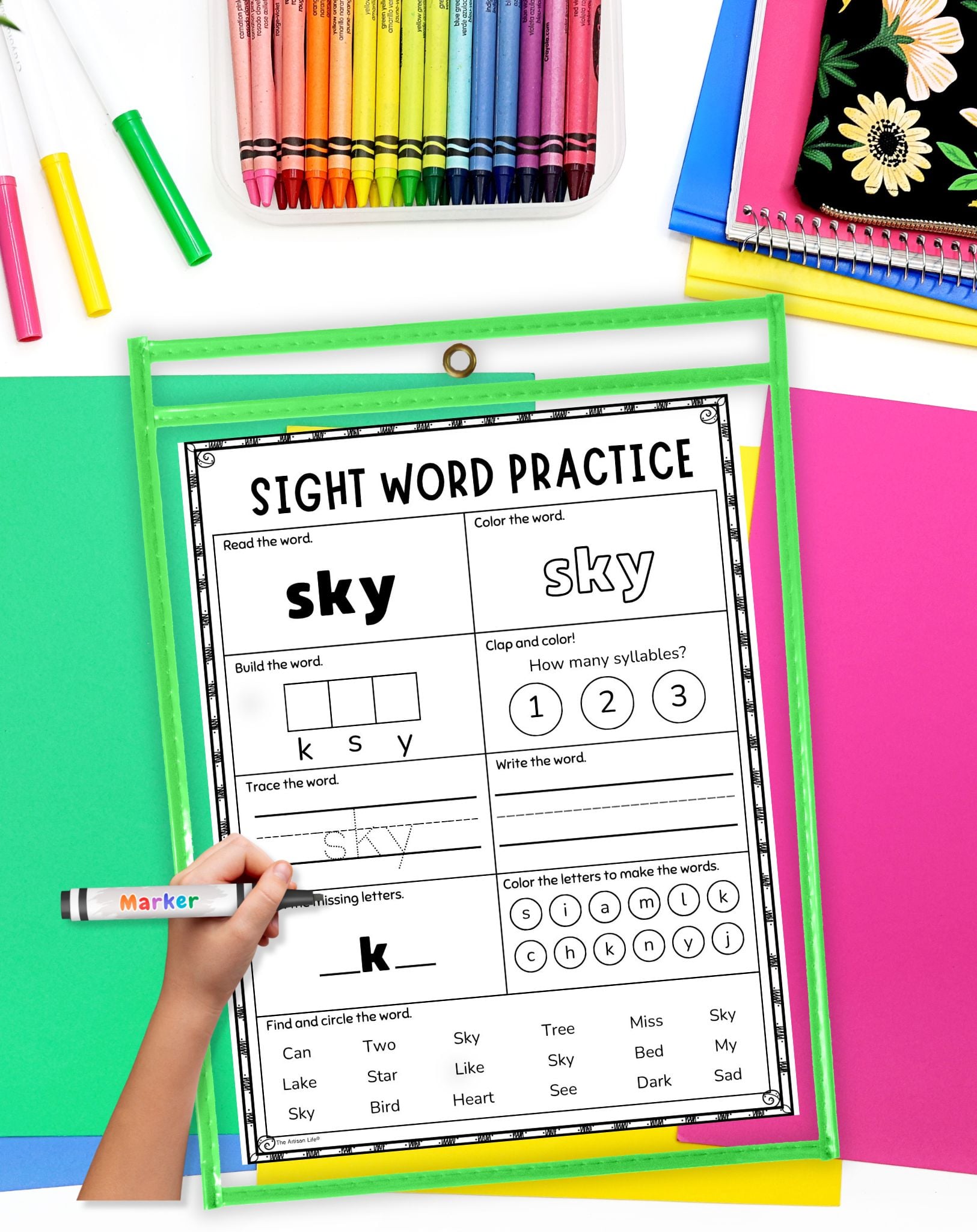 a child's hadn't holding a marker preparing to use a sight word worksheet in a dry erase pocket