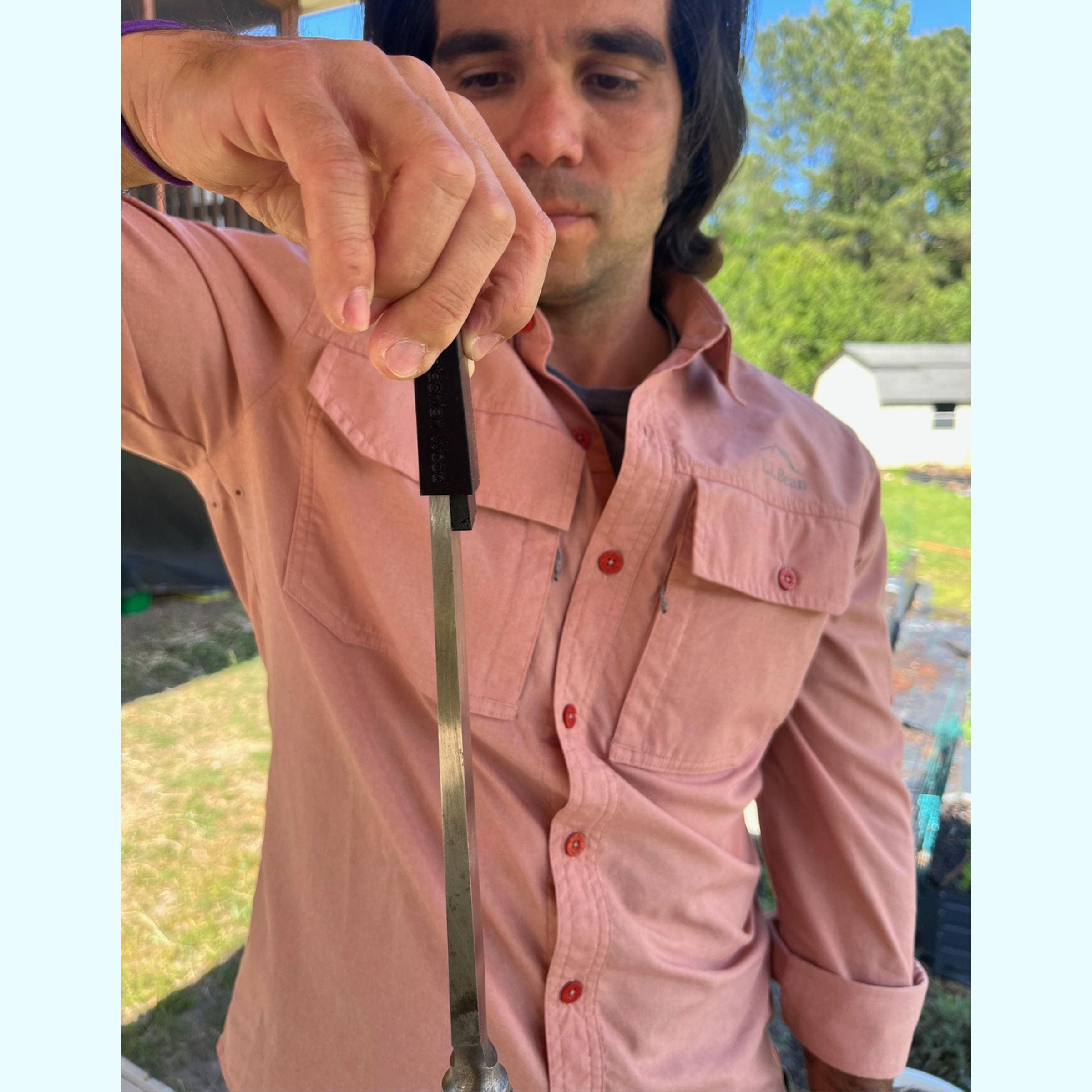 a man holding a timber framing chisel by the chisel guard