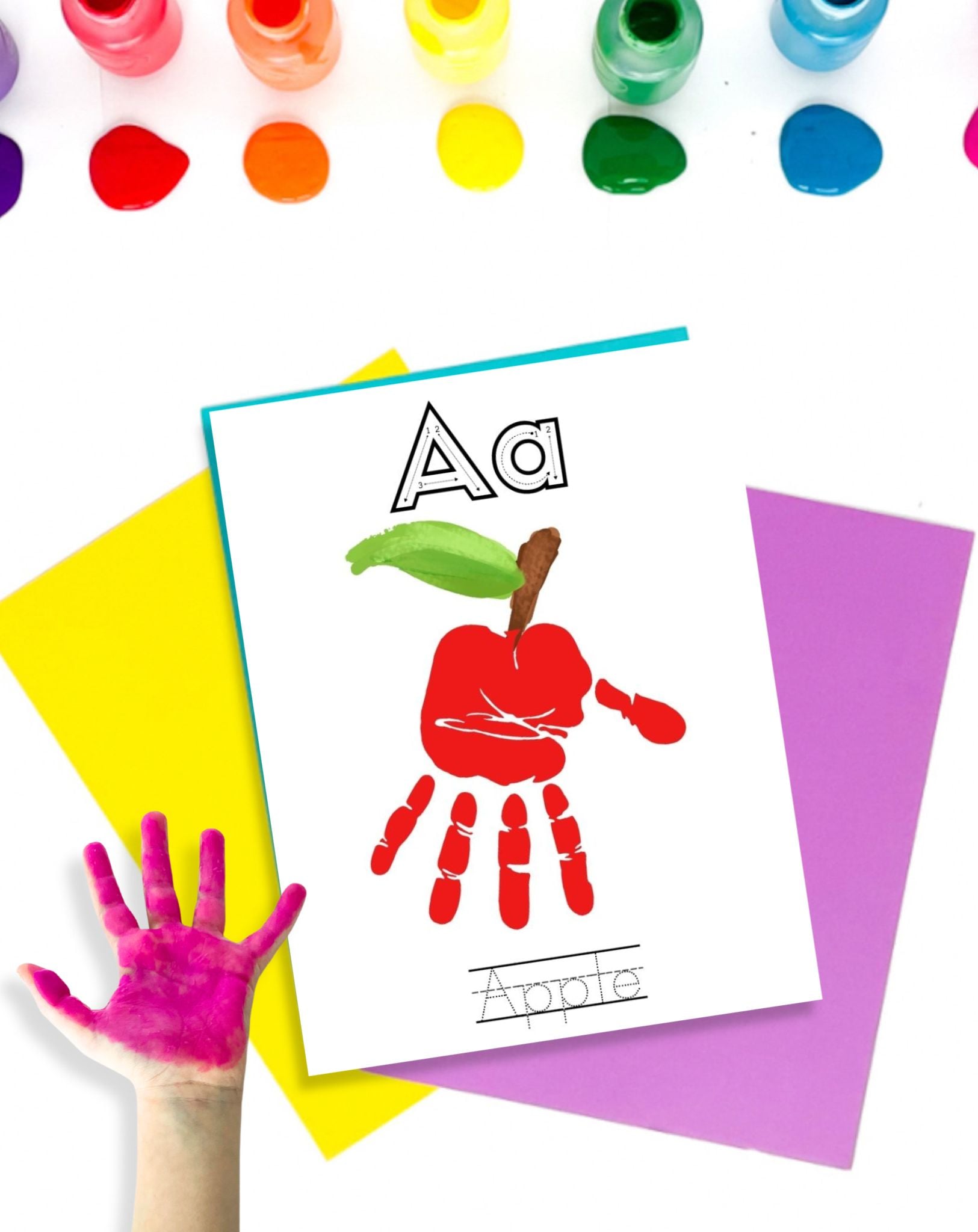 a hadn't with red paint and a handprint craft for an apple