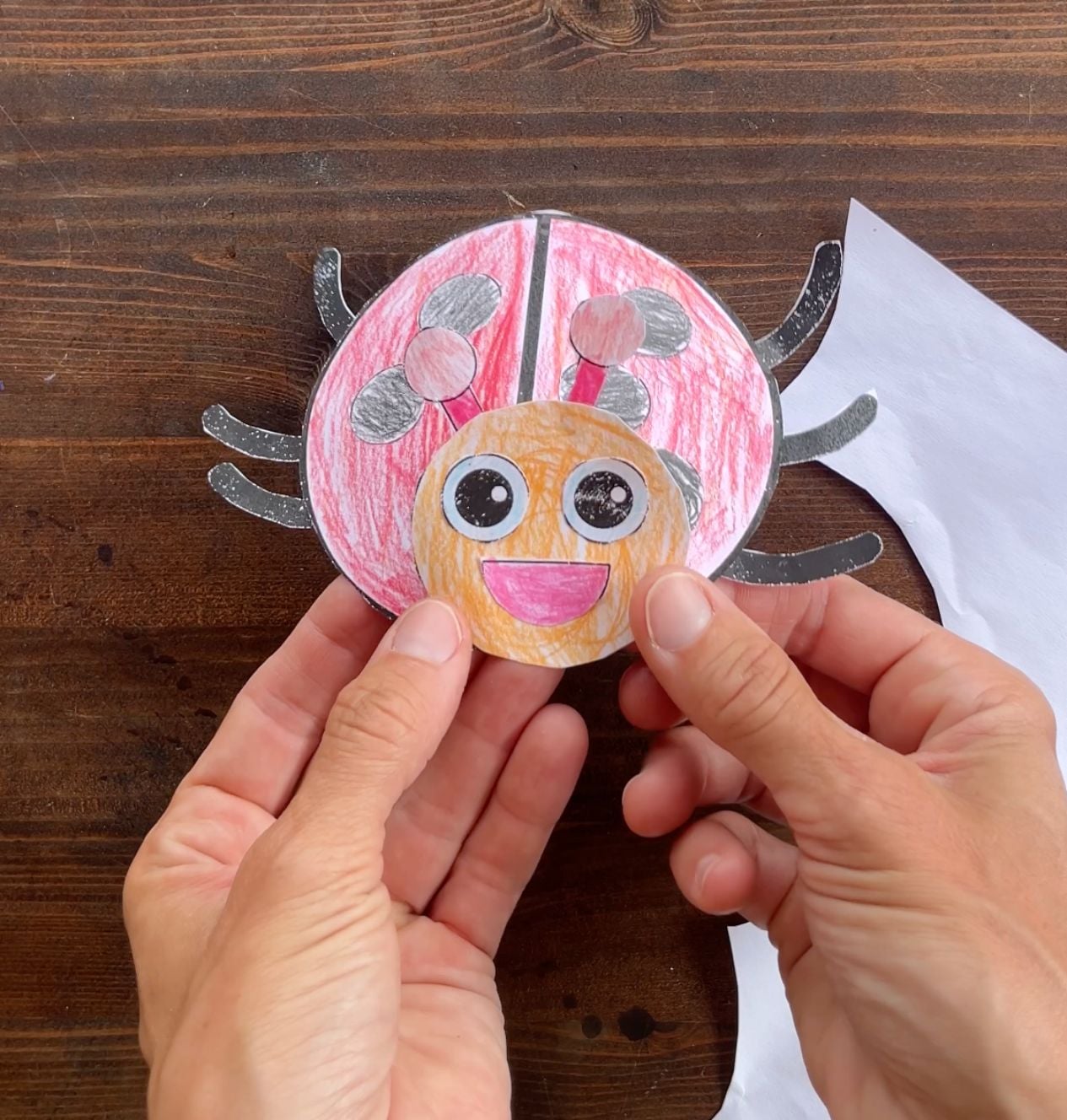 gluing face on paper ladybug craft