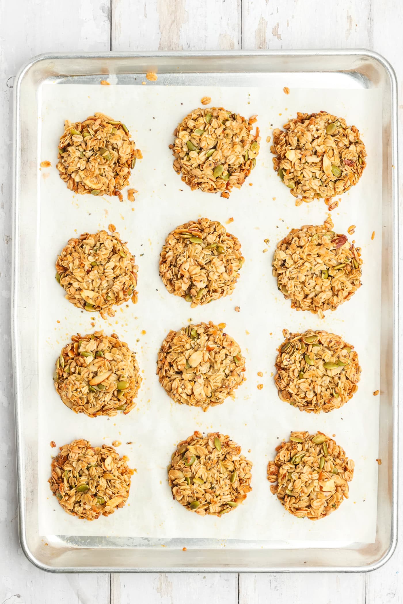 a baking sheet with unbakedaked granola cookies