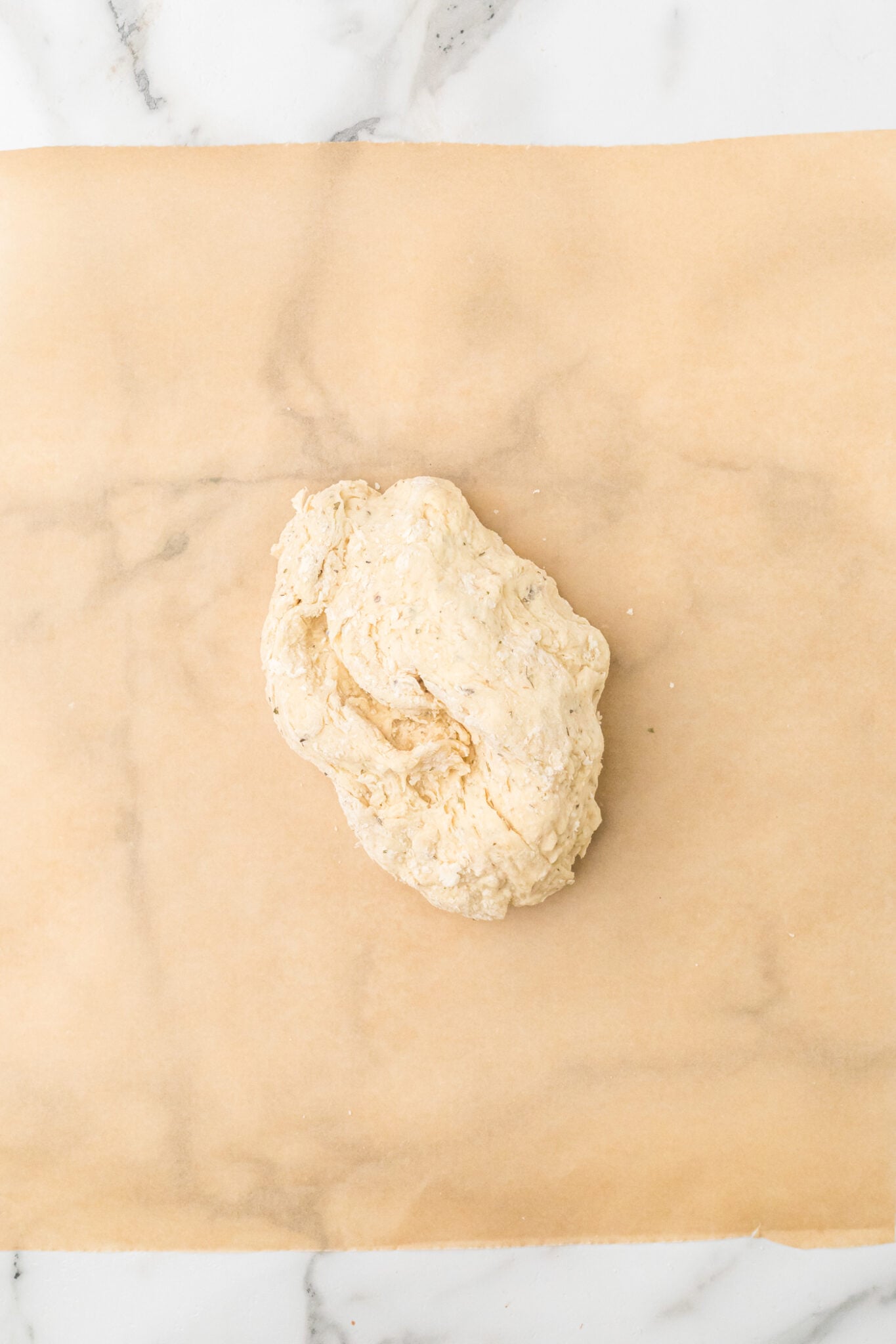 ball of dough for sourdough discord crackers on parchment paper