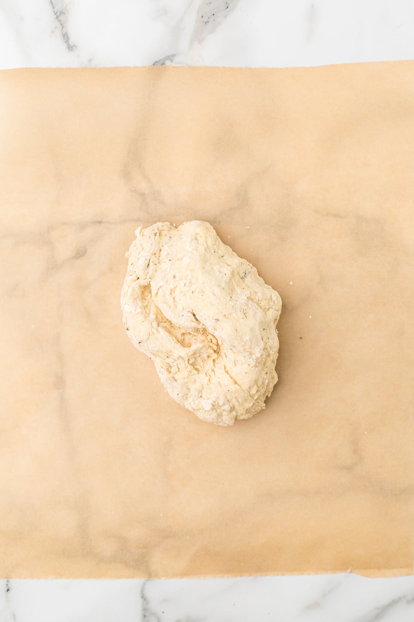 ball of dough for sourdough discord crackers on parchment paper