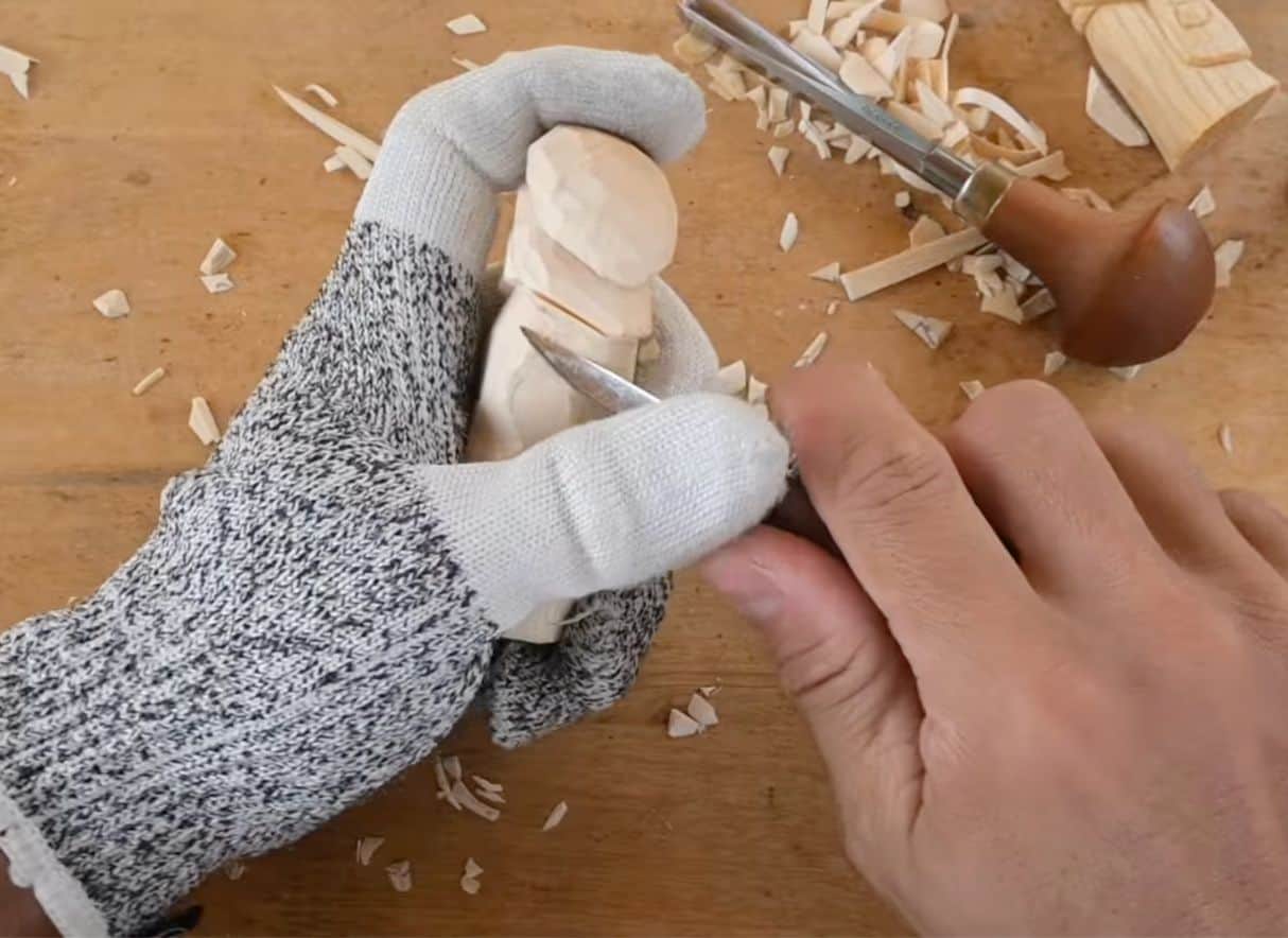 carving the hat on a mrs claus figure