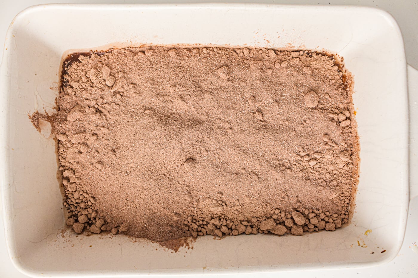 dry ingredients for a chocolate dump cake in a pan