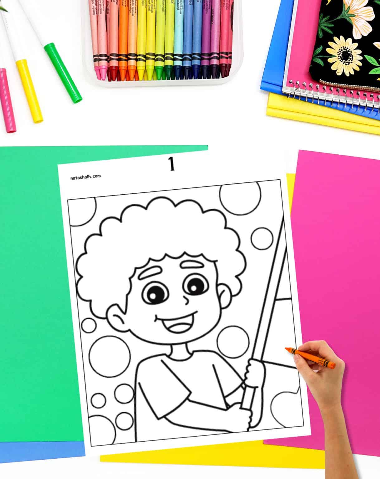 a hand with a crayon preparing to color the first page of a collaboration poster
