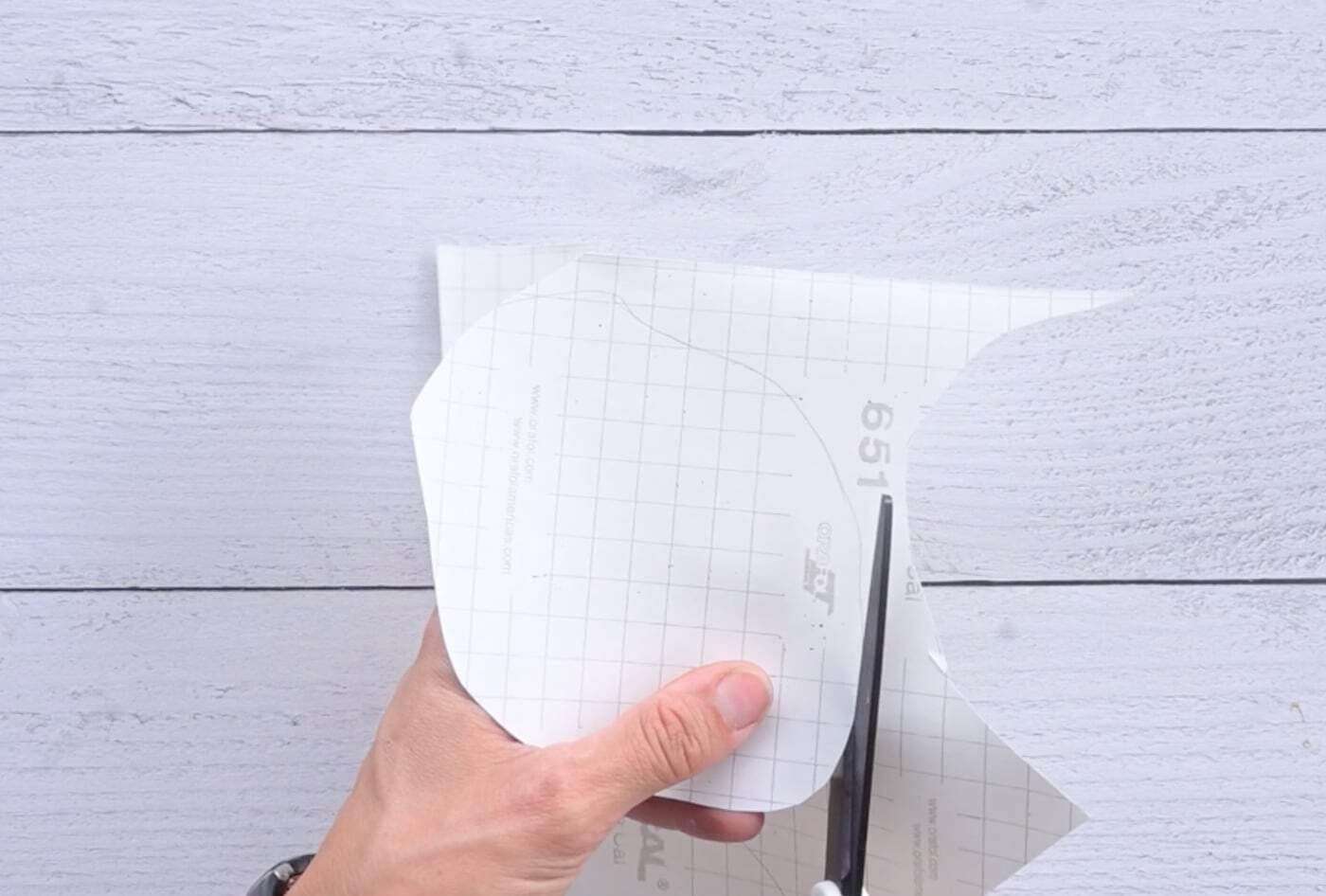 cutting out contact paper that will be used to laminate a paper squishy