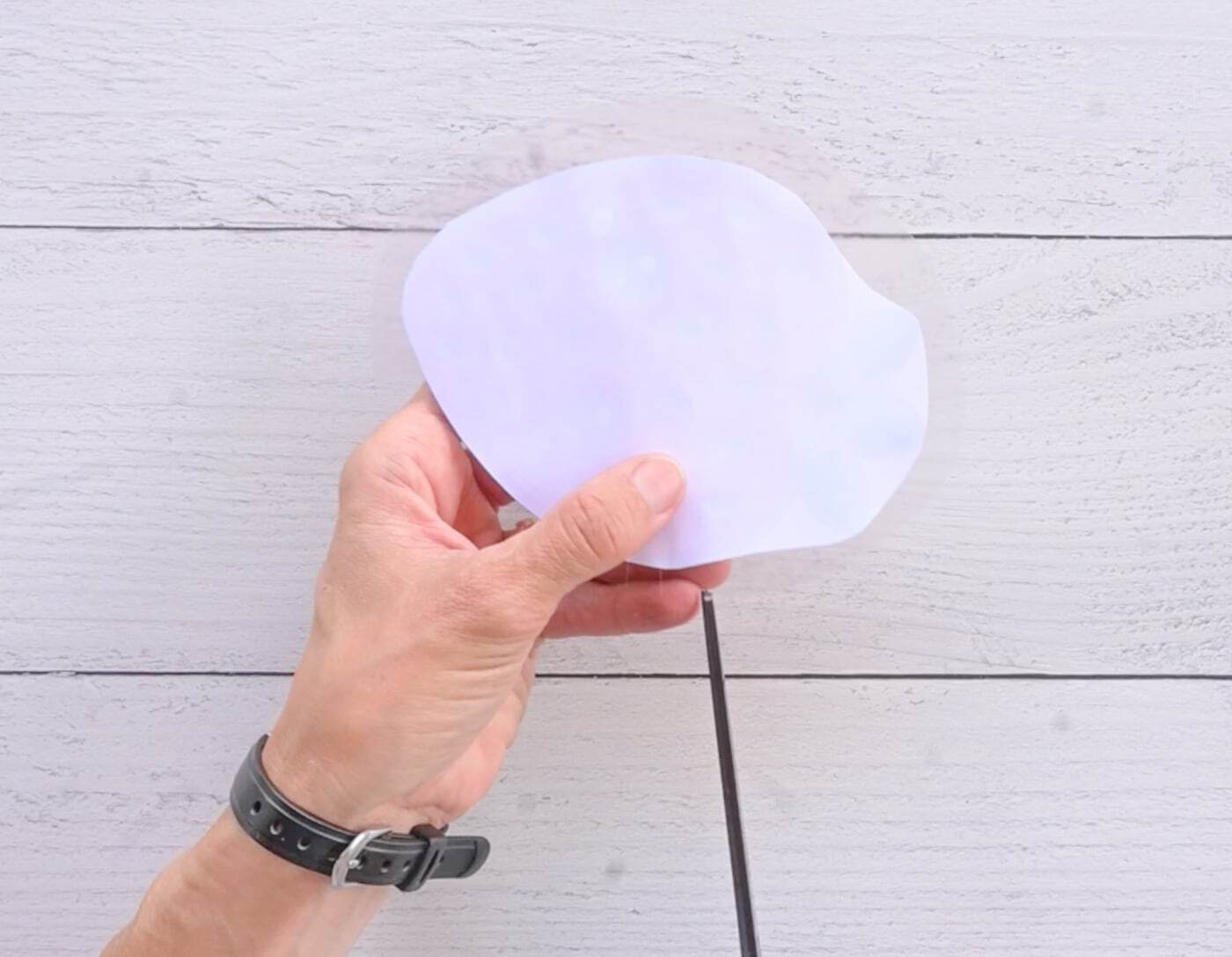 cutting tabs in contact paper to make a paper strawberry squishy