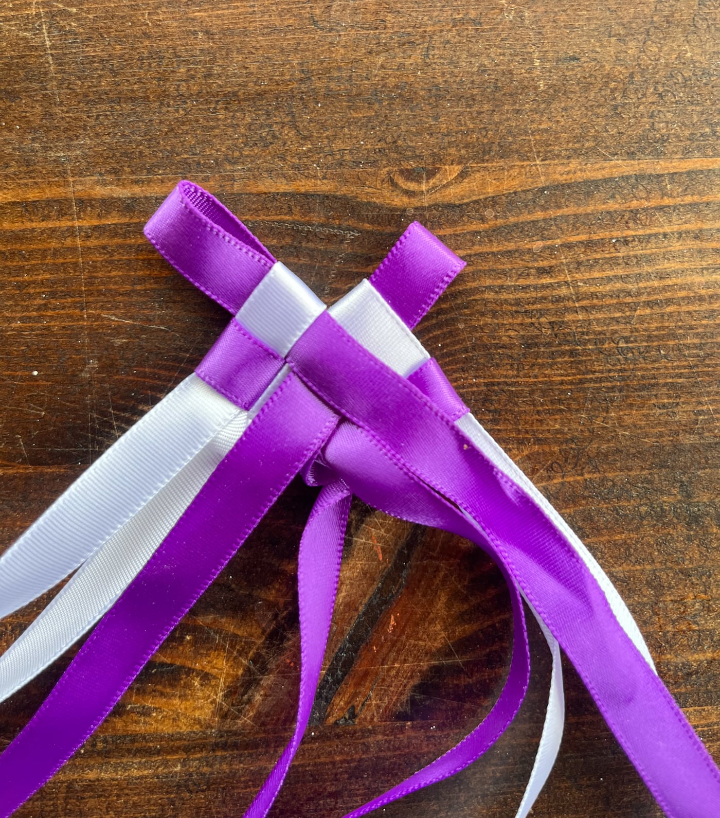 braiding a Hawaiian ribbon lei with four strands