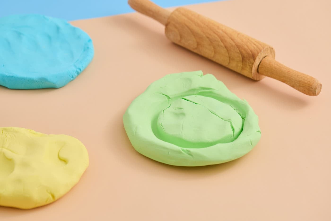 playing with cloud dough with a jar and rolling pin