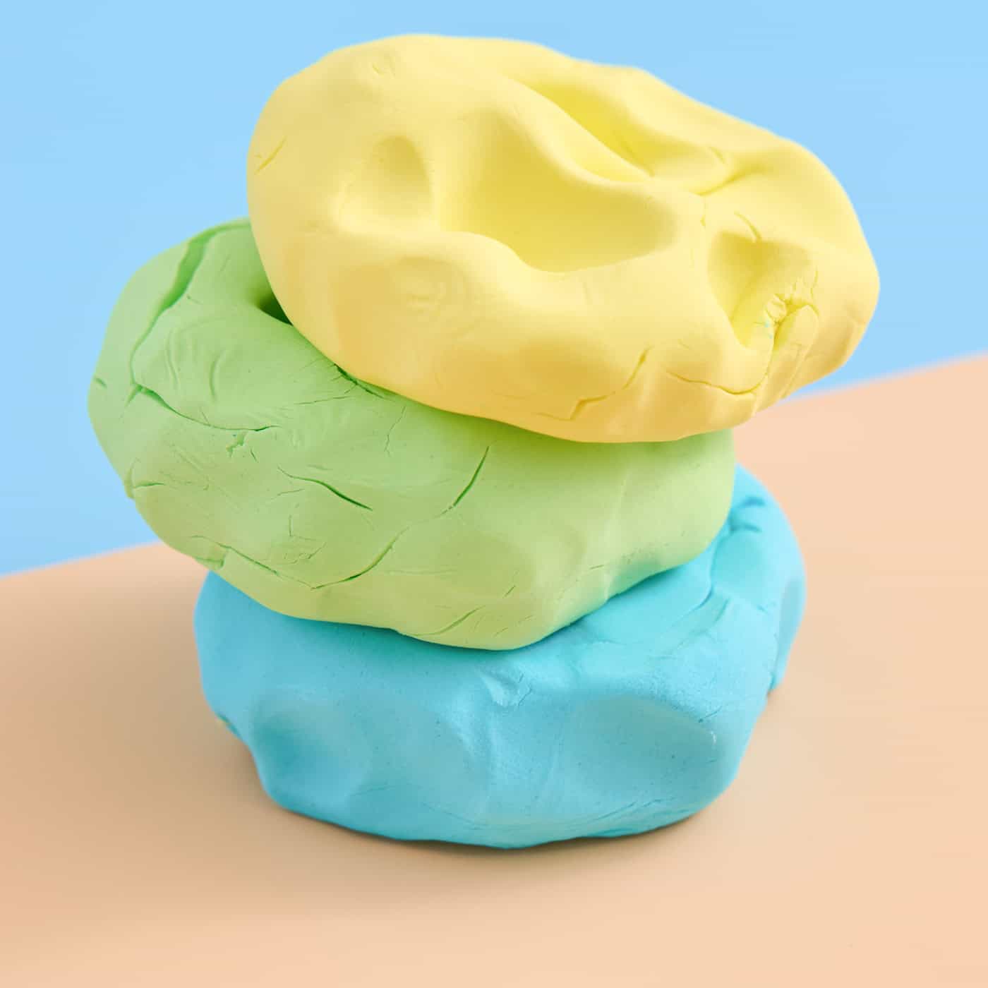 a stack of three colors of homemade cloud dough