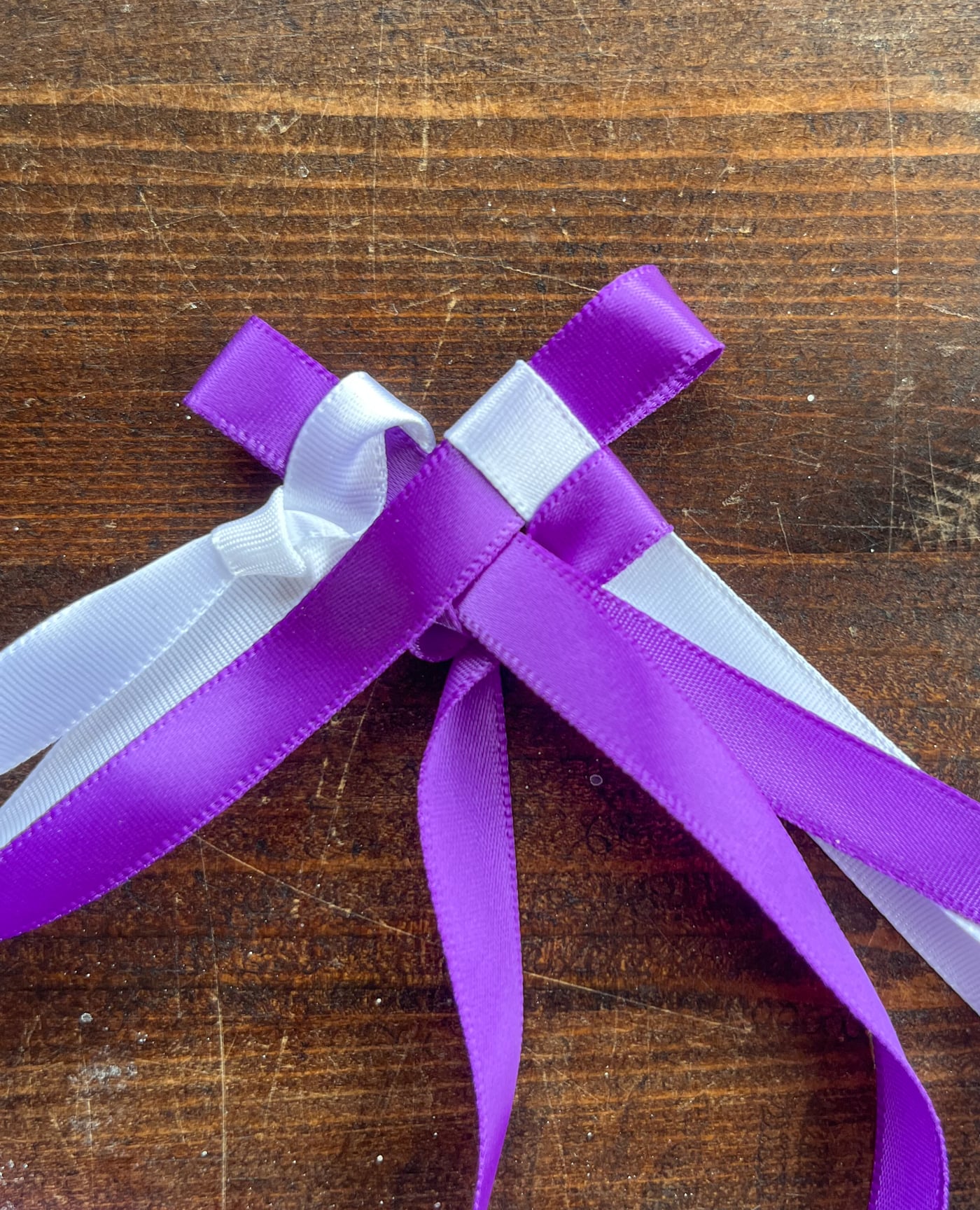 four ribbons being used too tart the braid for a Hawaiian ribbon lei