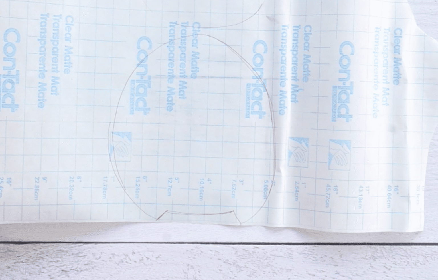 outline of an avocado traced on contact paper