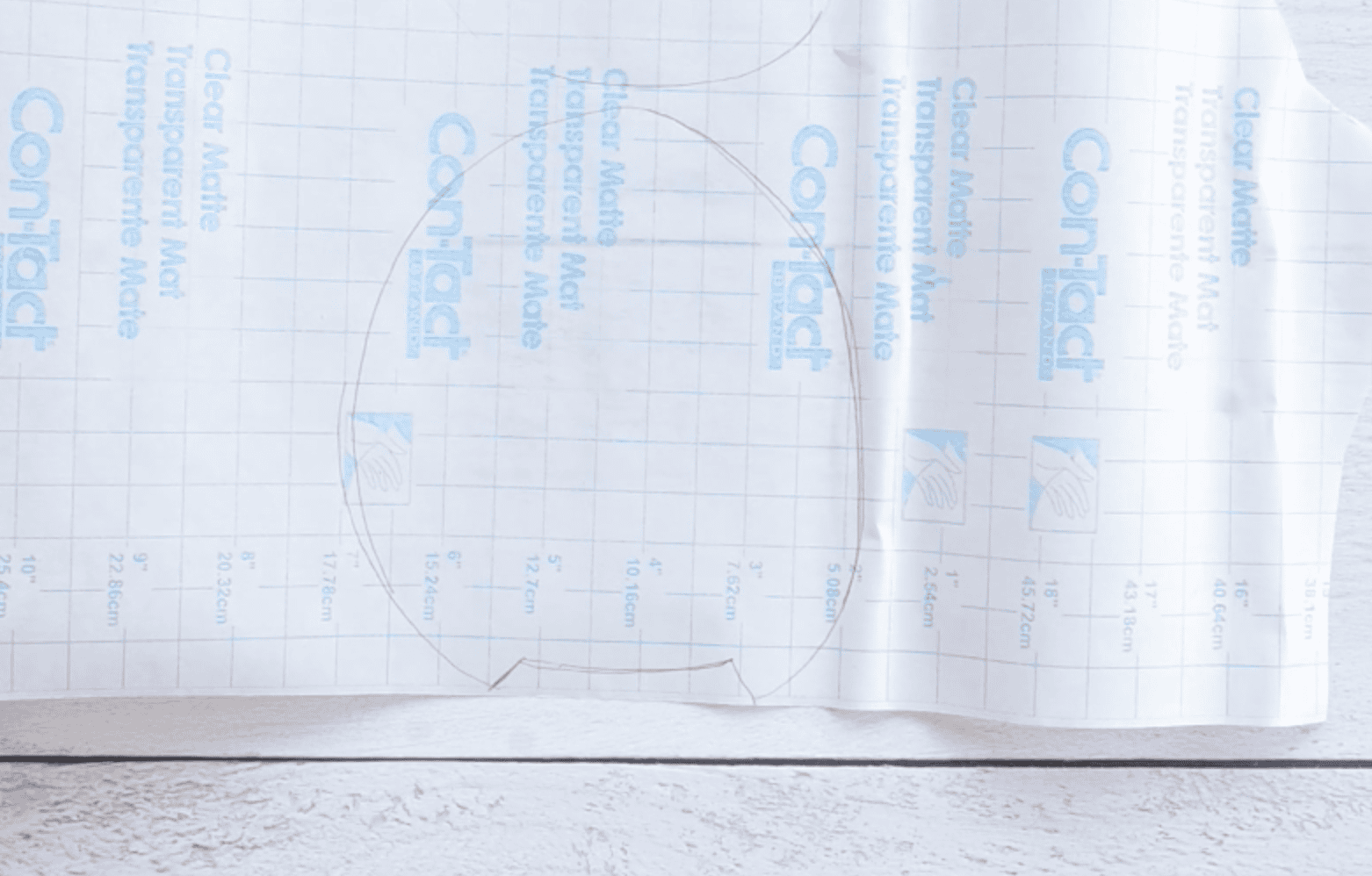 outline of an avocado traced on contact paper