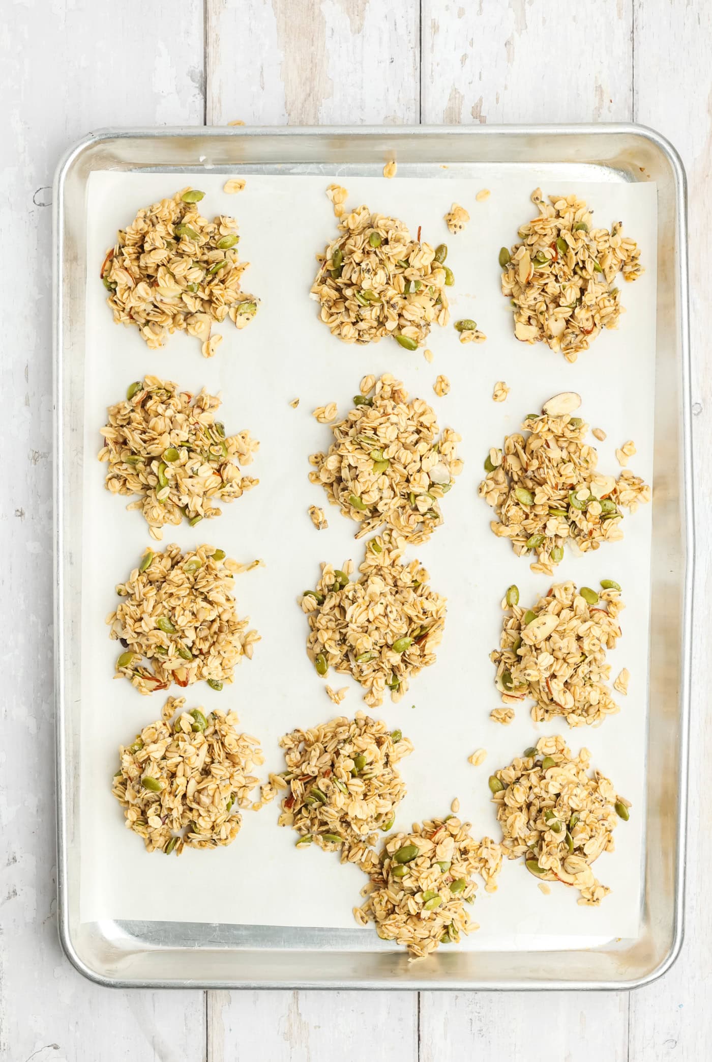 a baking sheet with unbaked granola cookies