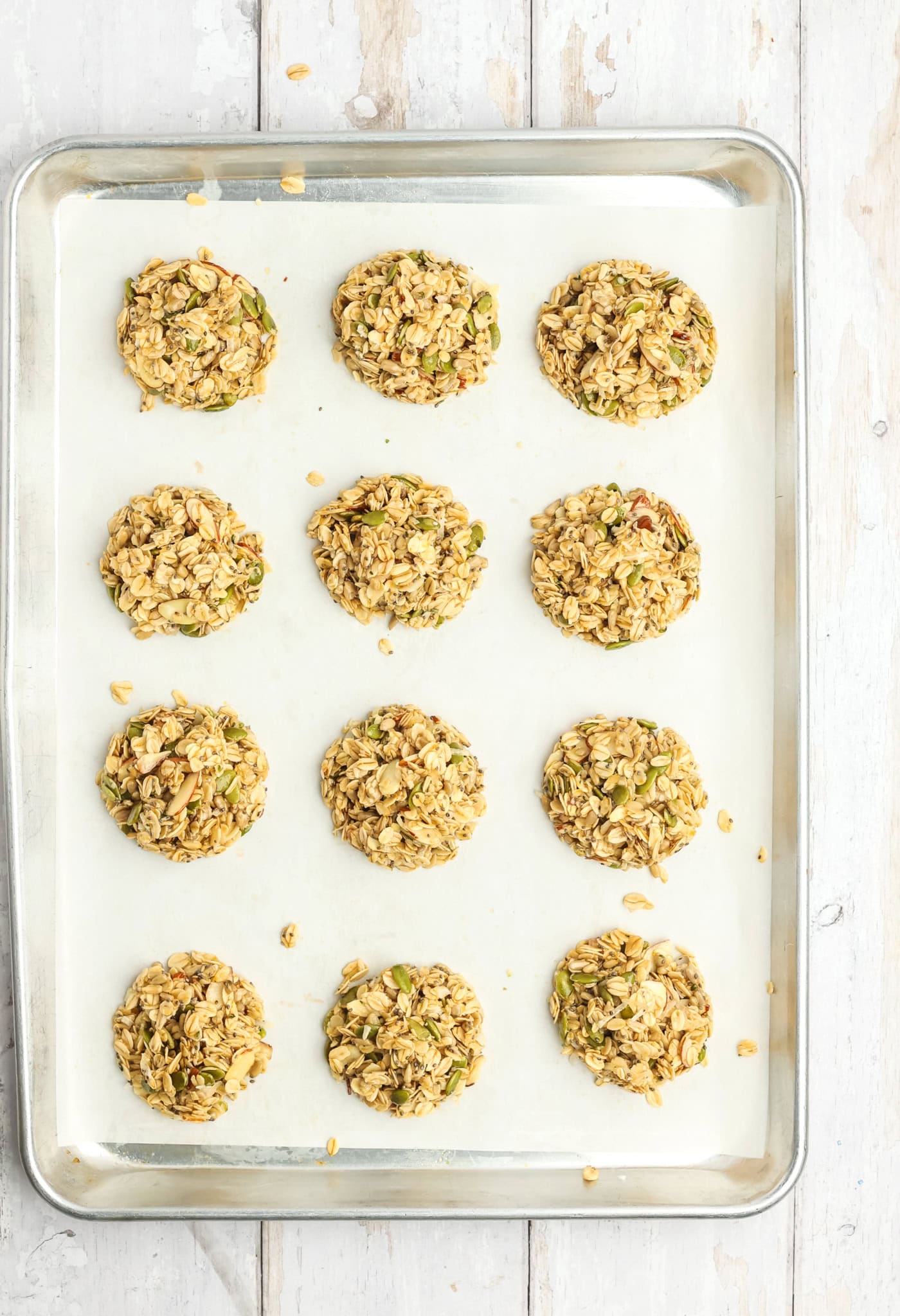 a baking sheet with partially granola cookies
