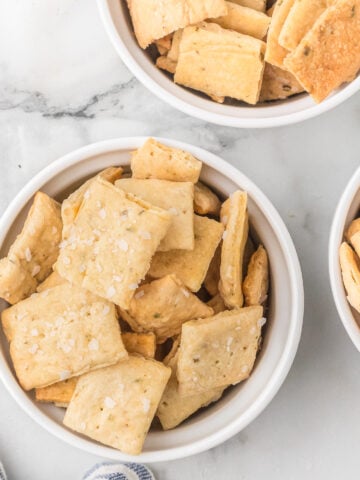 a top down photo of three ramekins of homemade sourdough discard crackers