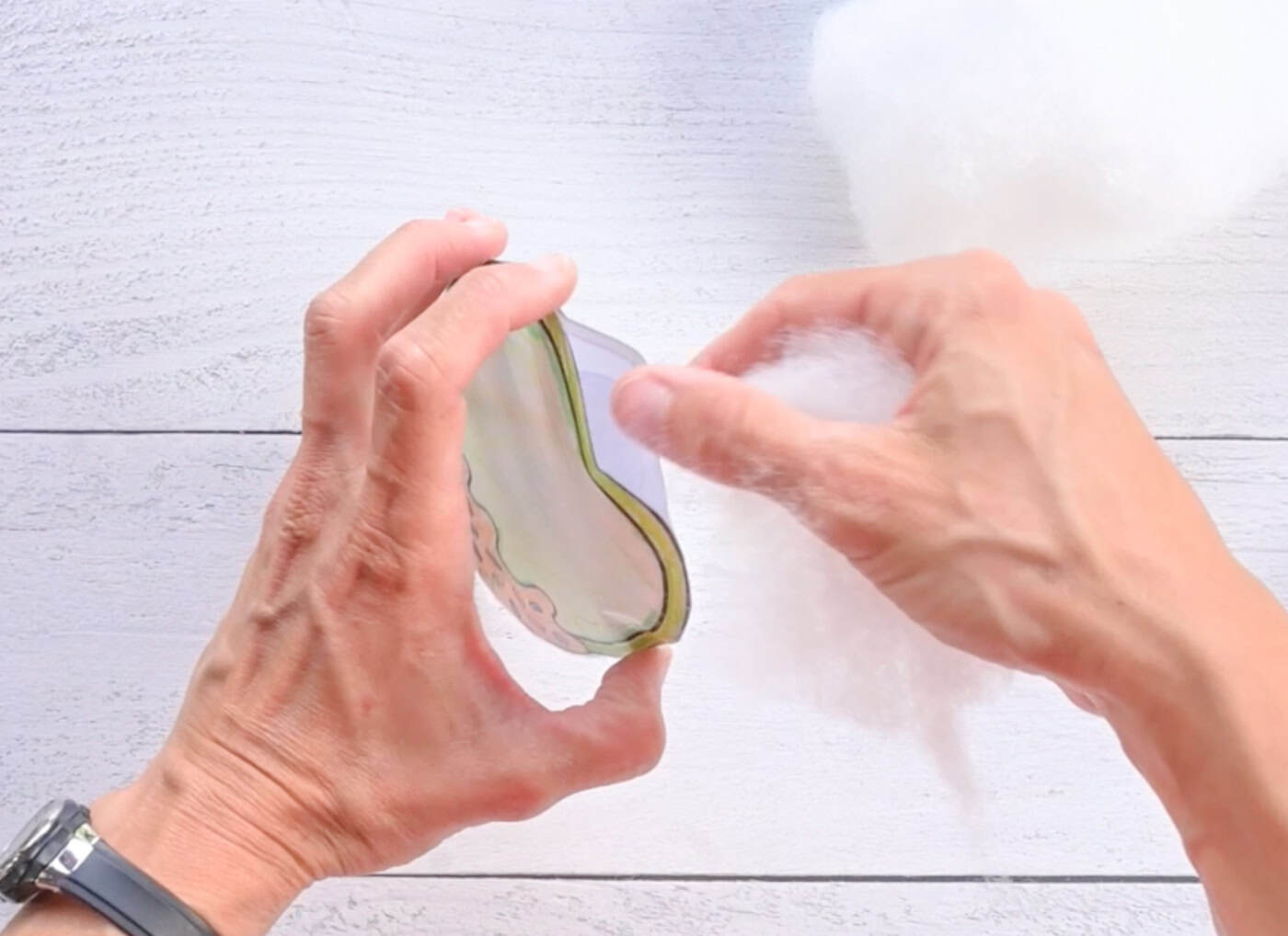 adding stuffing to a diy paper avocado squishy