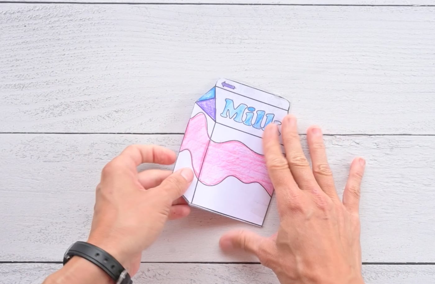 laminating the back of a paper milk carton squishy with contact paper