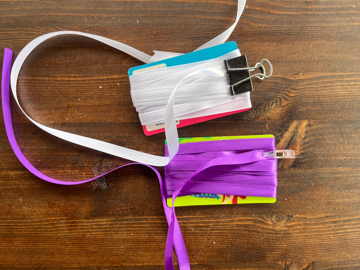 two cardboard bobbins wrapped with ribbon.