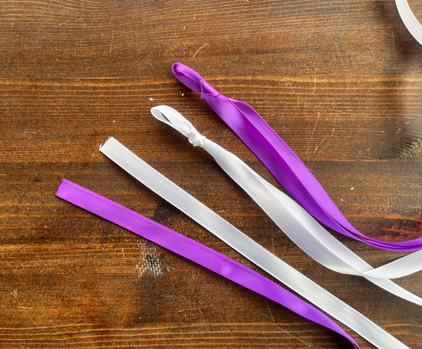 four pieces of ribbon. Two have slip knots tied in them