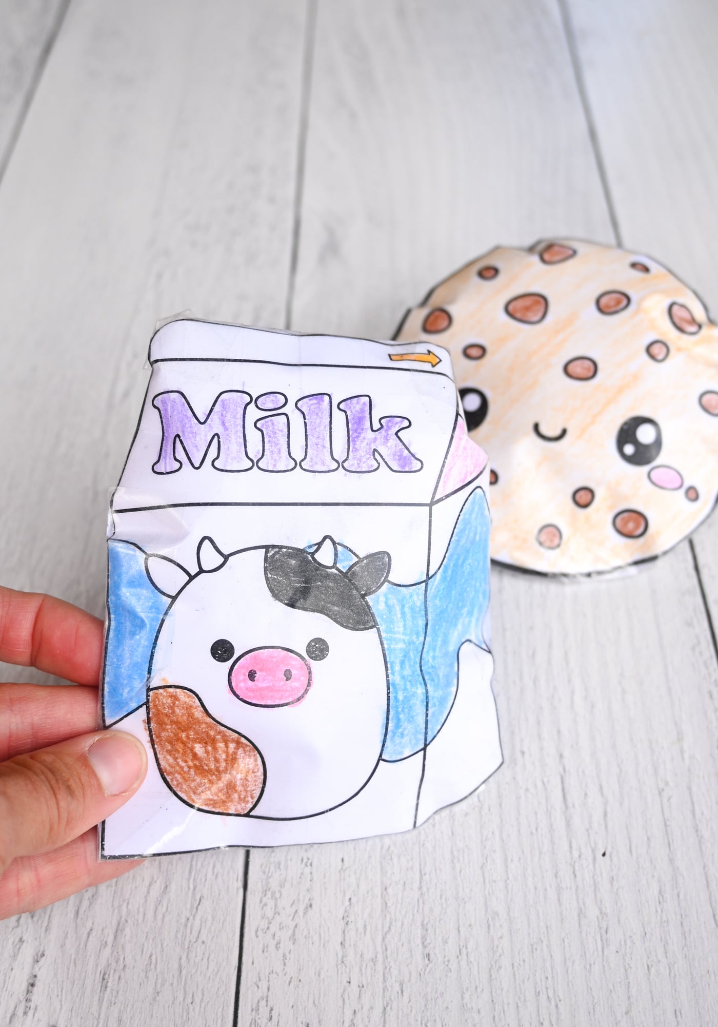 a kawaii milk carton paper squishy in front of a cookie paper squishy