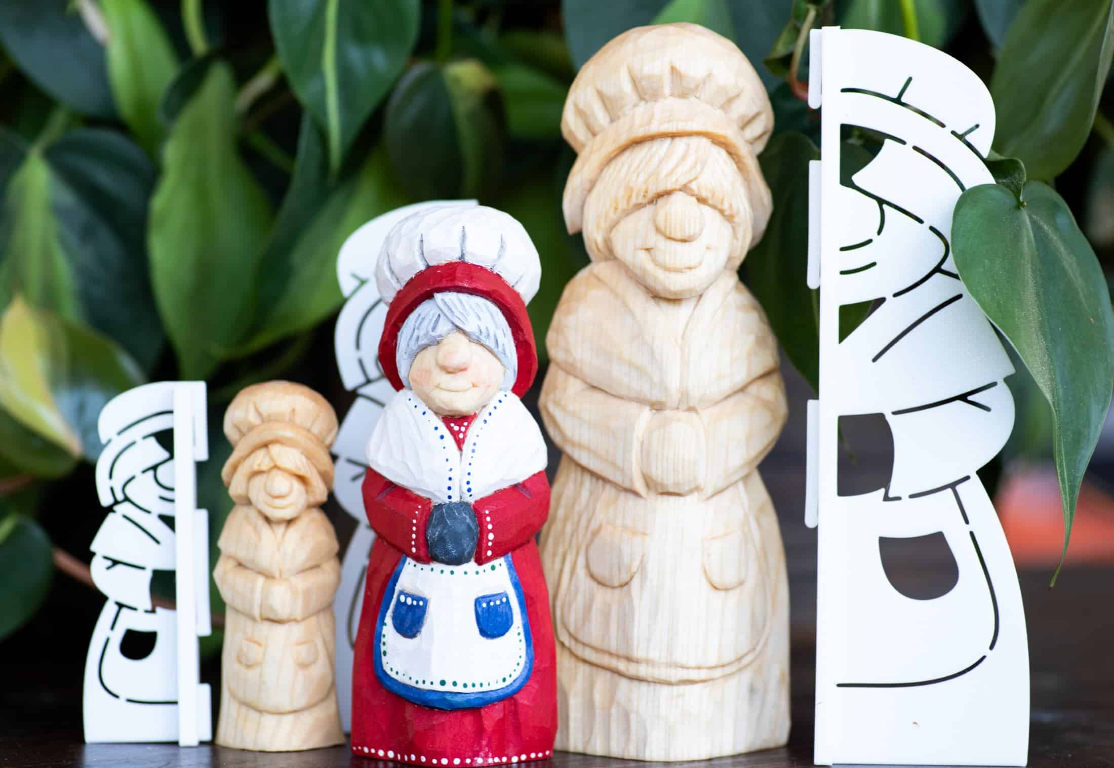 mrs claus wood carvings next to stencils used for layout