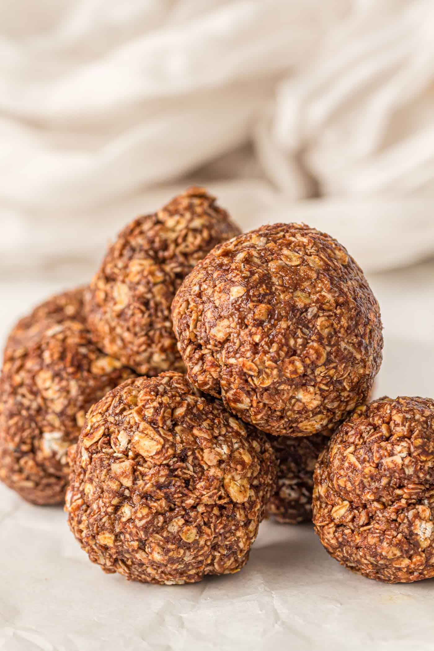 a close up of several large chocolate oatmeal peanut butter balls