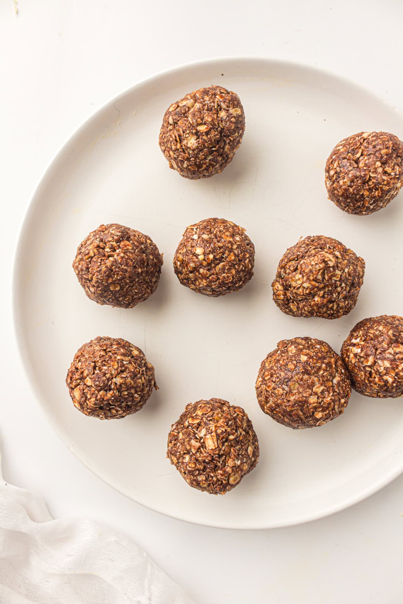 a plate with about half a dozen no bake oatmeal peanut butter energy balls