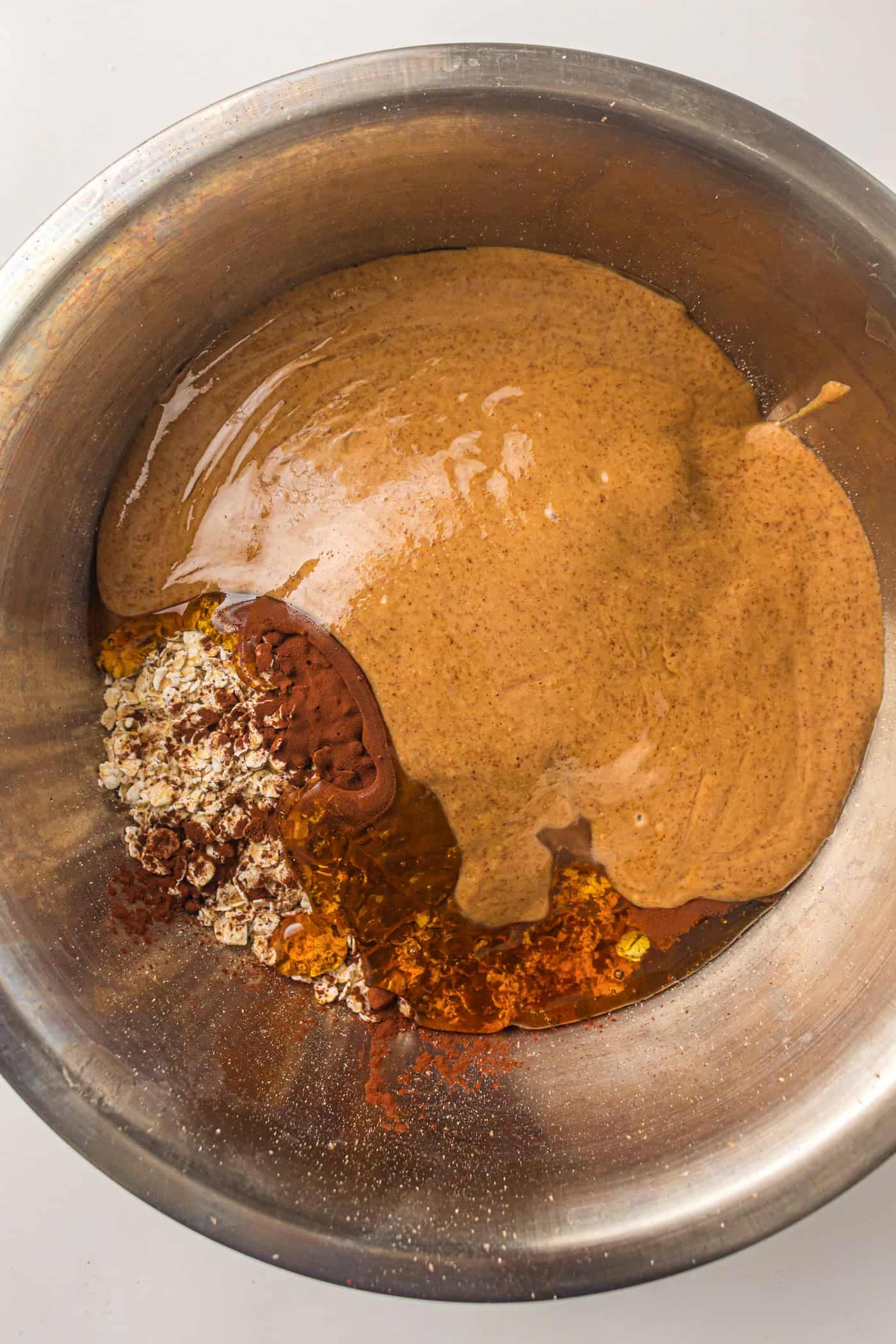 peanut butter and oatmeal in a large metal bowl