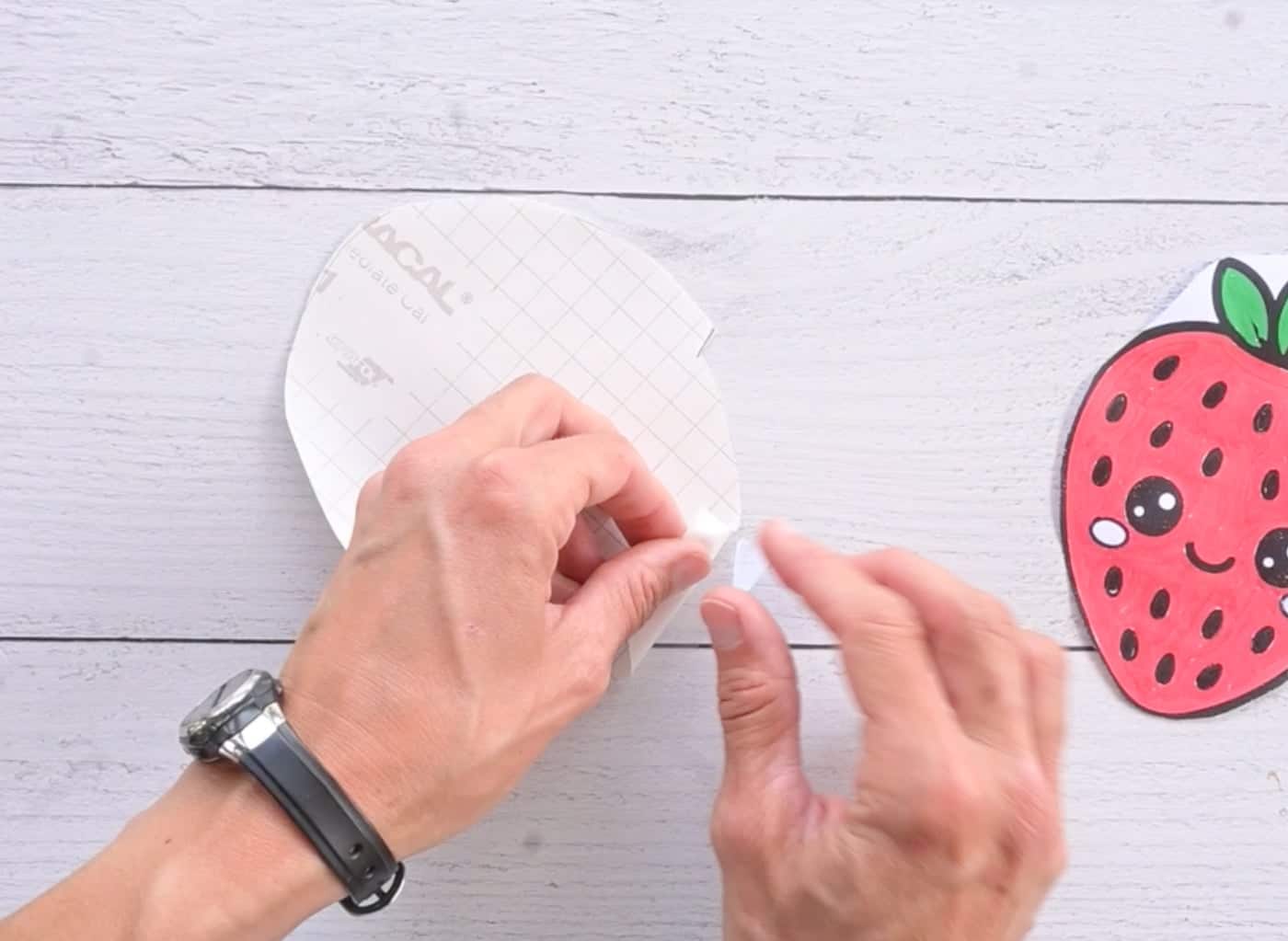 peeling backing paper off contact paper