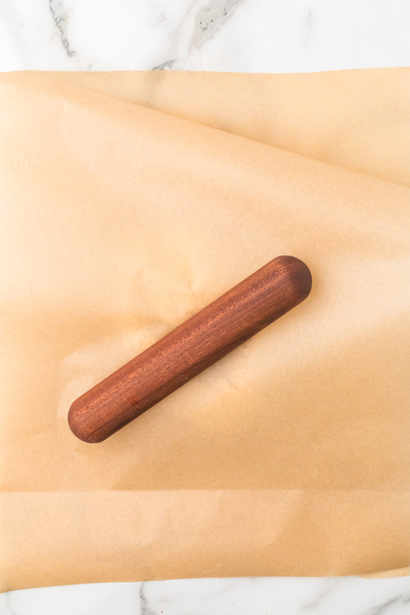 rolling out ball of dough for sourdough discord crackers
