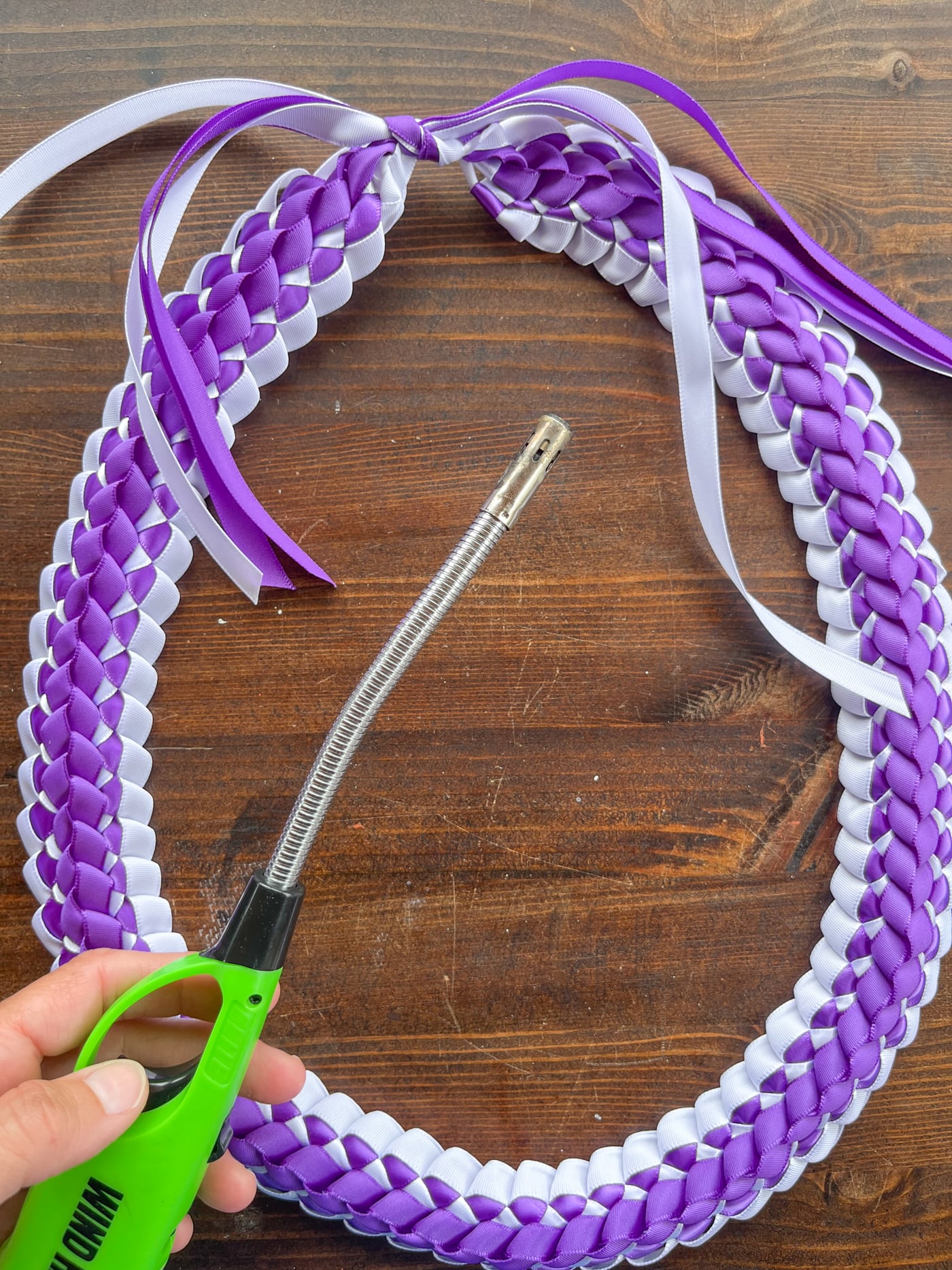 using a lighter to singe the ends of ribbon to prevent fray