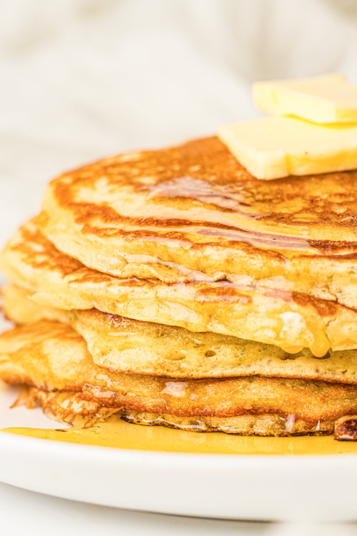 a stack of fluffy sourdough discard pancakes with butter on top
