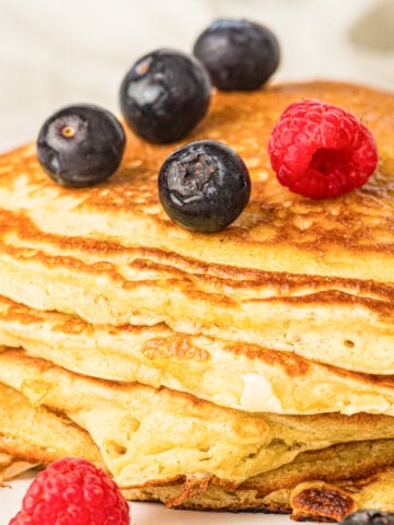 sourdough discard pancakes with blueberries and raspberries on top