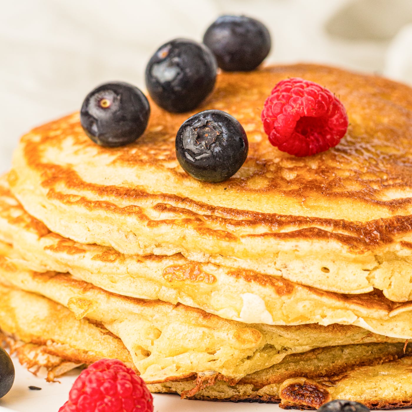 sourdough discard pancakes with blueberries and raspberries on top