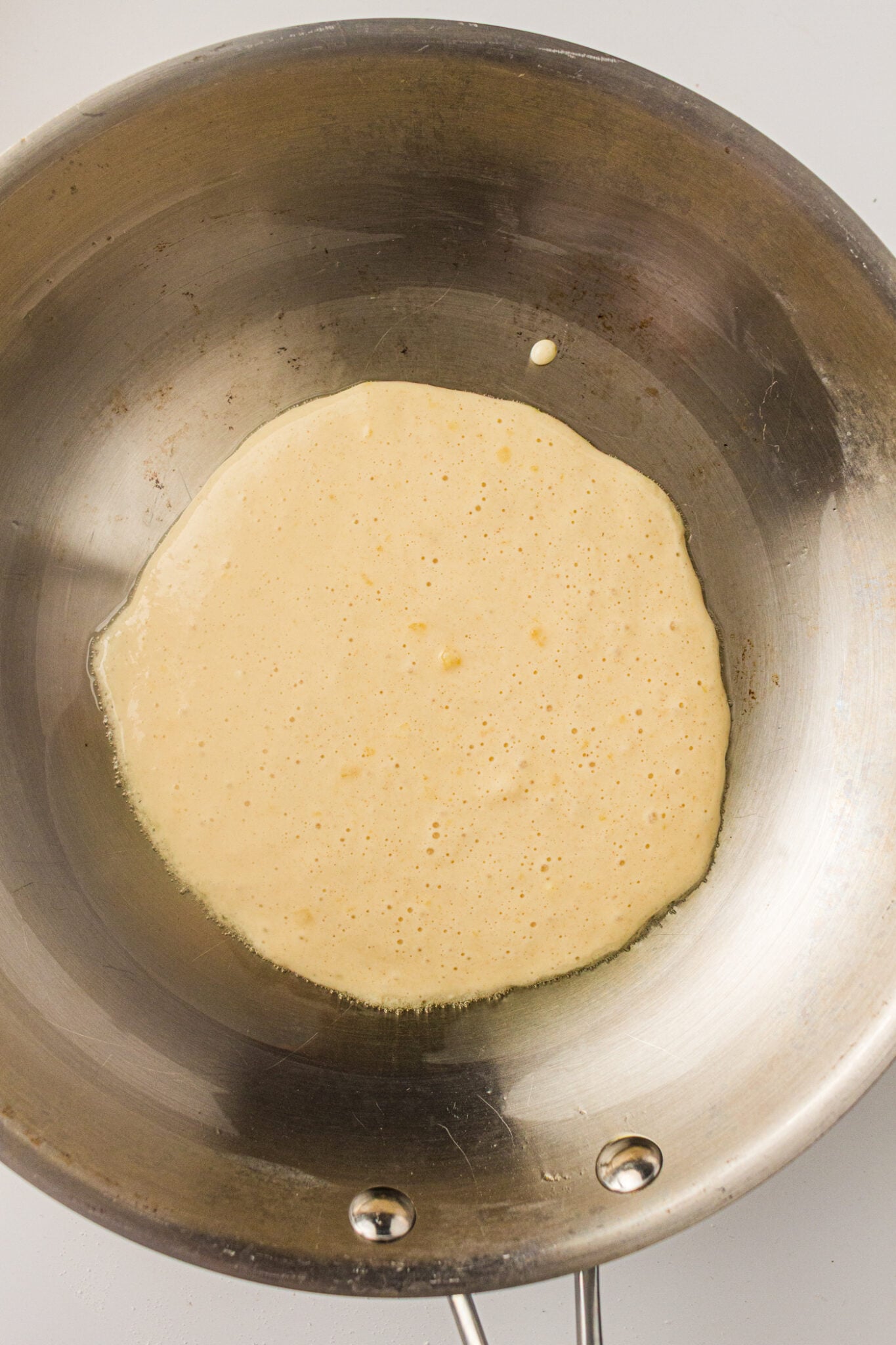 pancake batter in a stainless pan