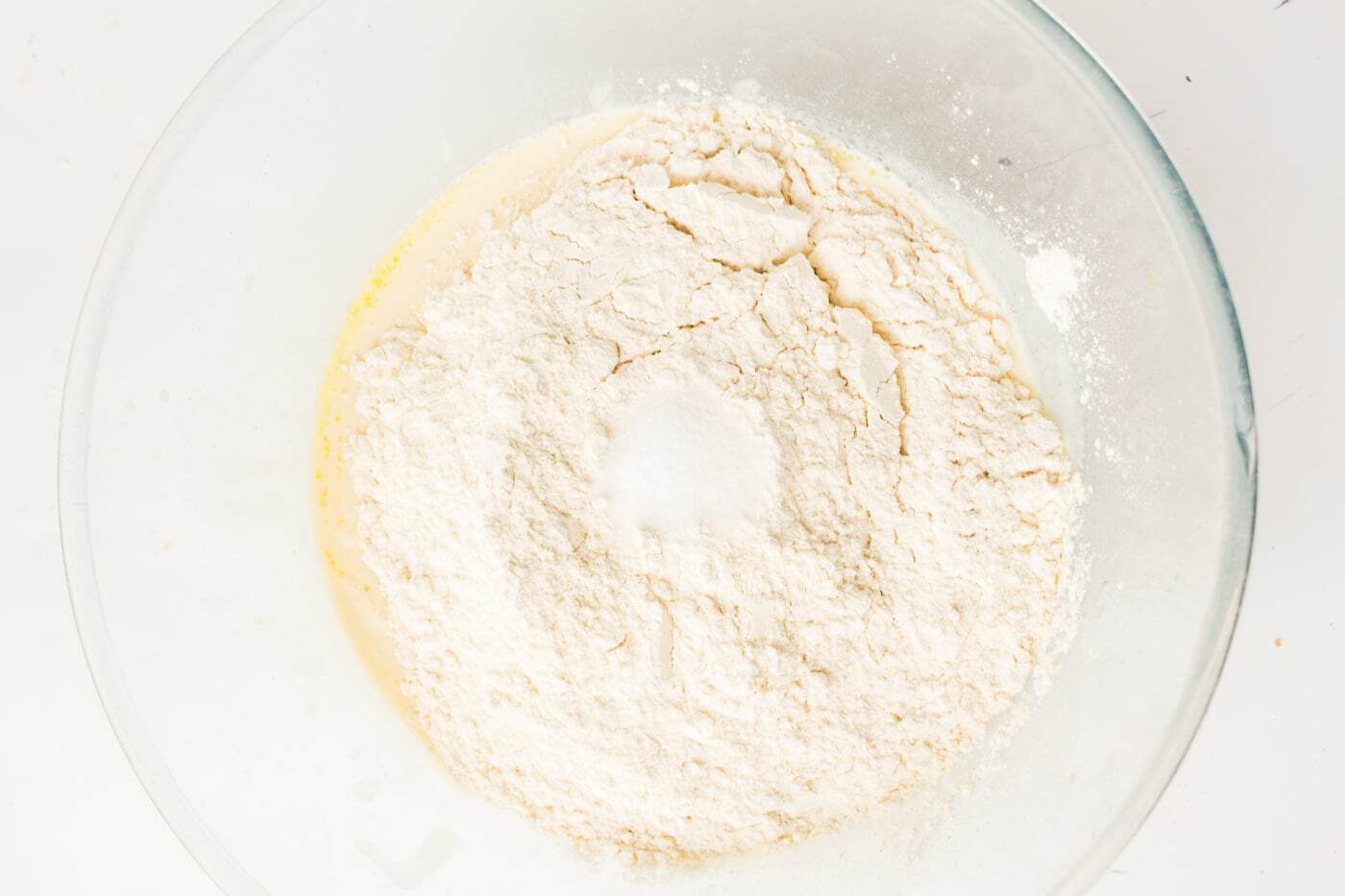 adding flour to make a loaf of sourdough sandwich bread