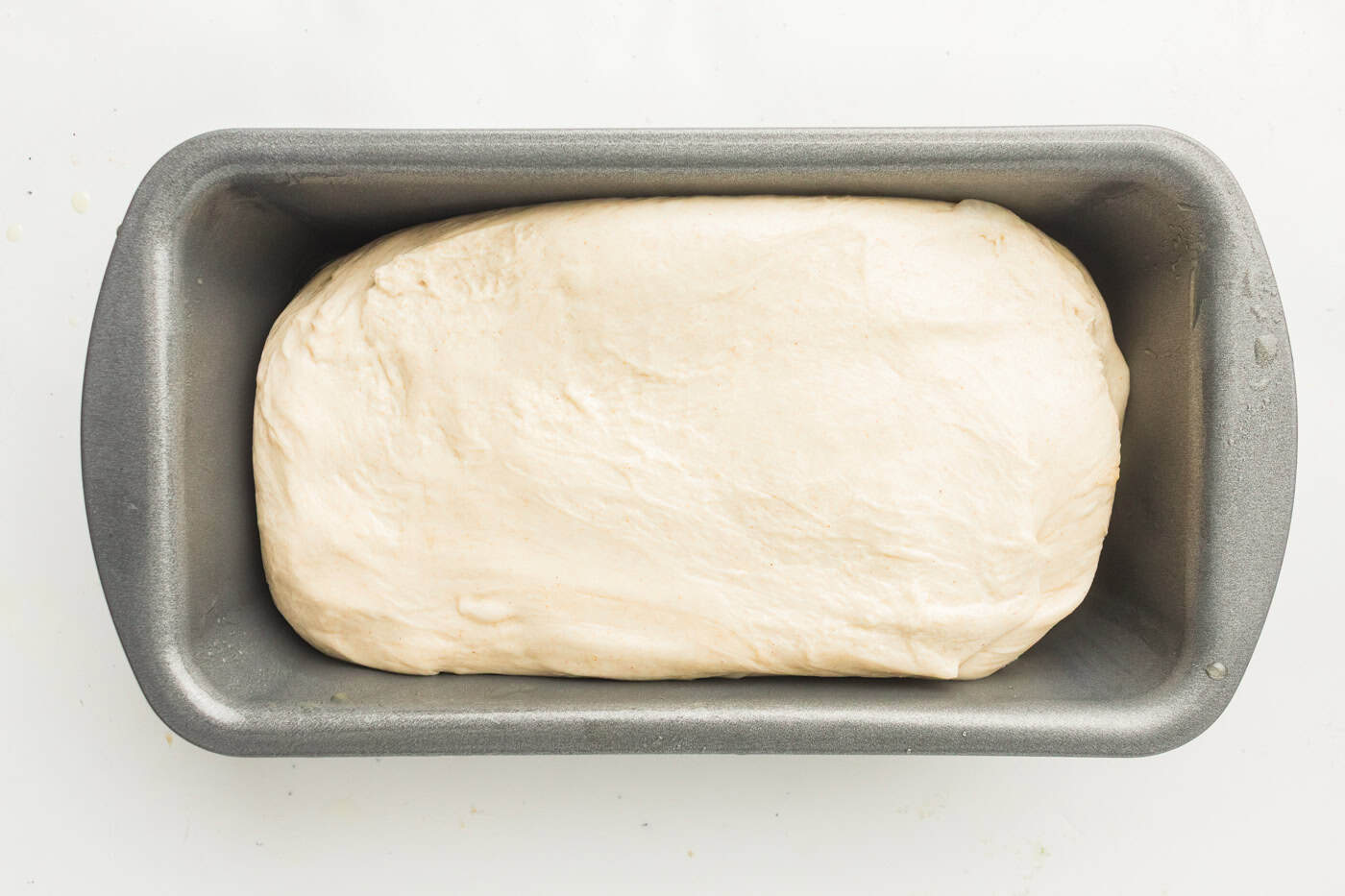 sourdough dough in a loaf pan for a loaf of sourdough sandwich bread