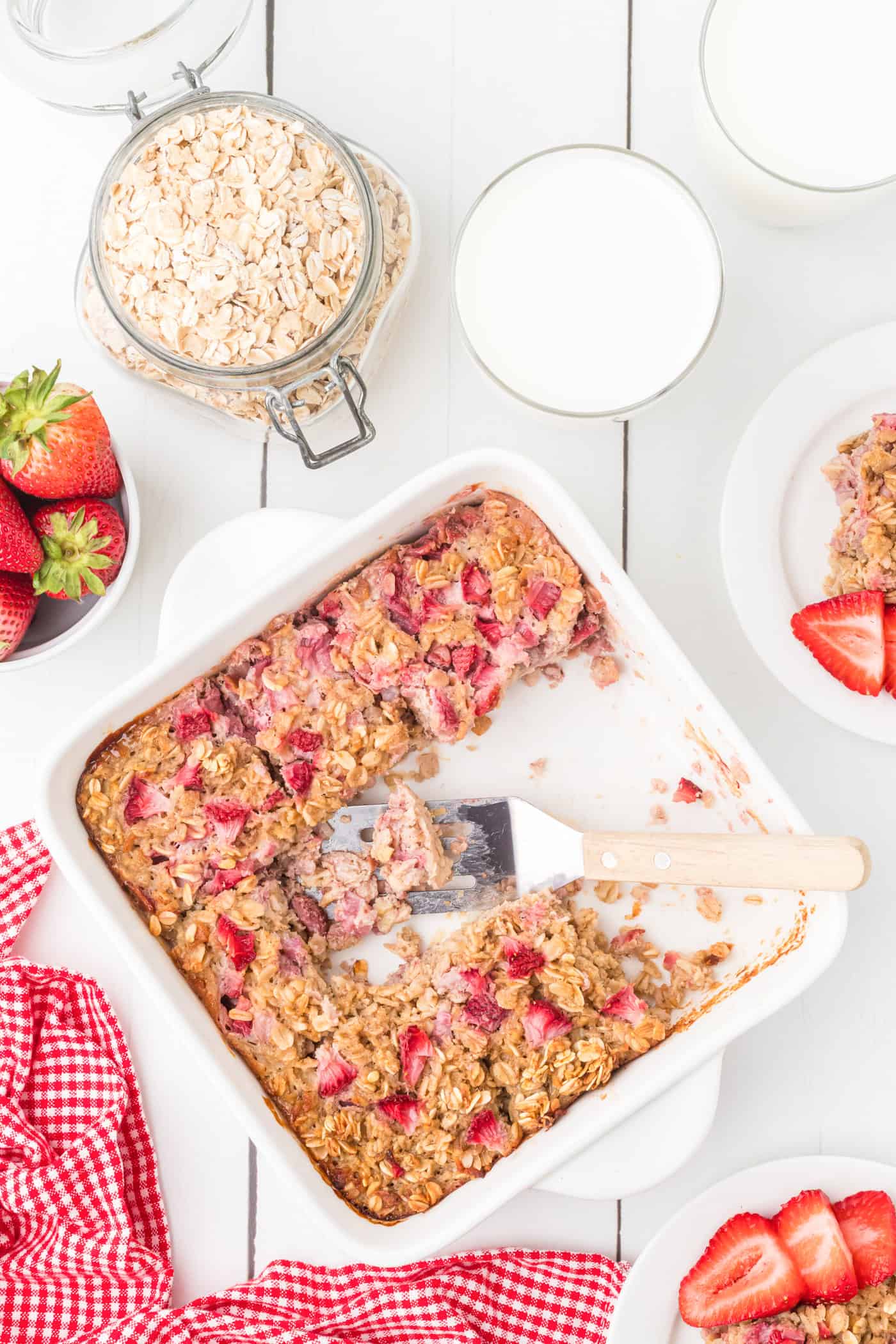 a top down photo of a dish of strawberry baked oatmeal being served