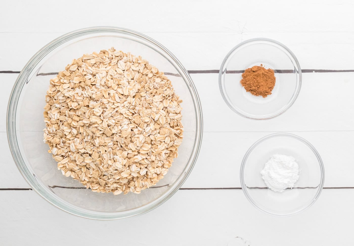 oatmeal, cinnamon, and baking powder prepared for making strawberry baked oatmeal