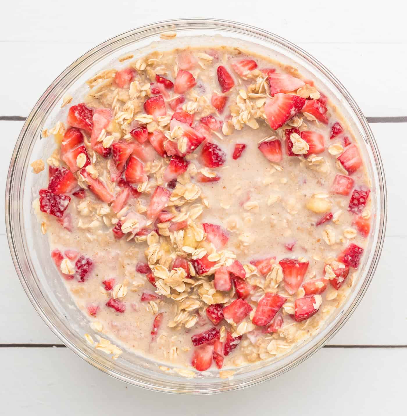 ingredients for strawberry baked oatmeal in a large glass bowl