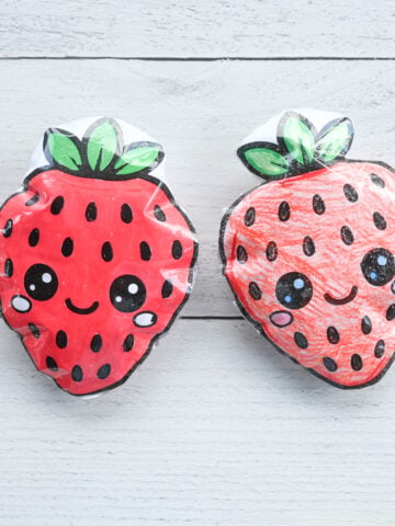 two paper squishy toy strawberries