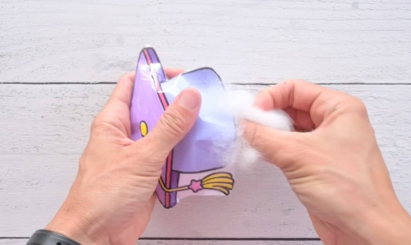 stuffing a diy paper squishy of a cute graduation cap