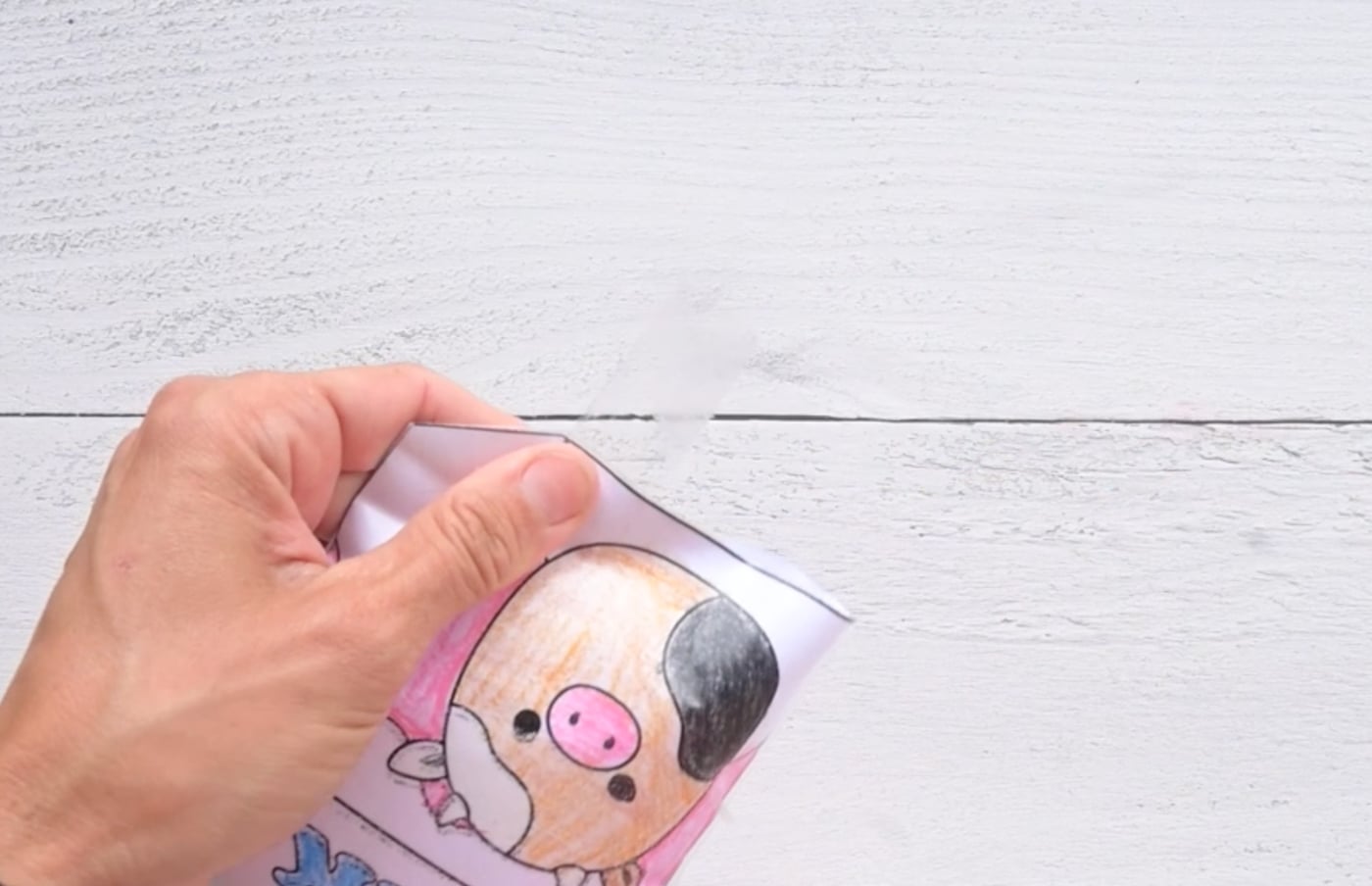 taping a paper milk carton squishy shut