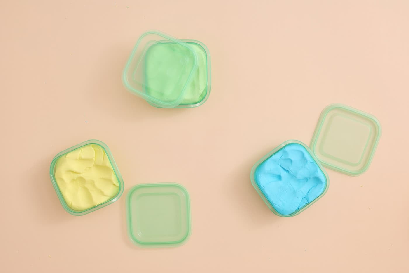 three small containers of homemade cloud dough