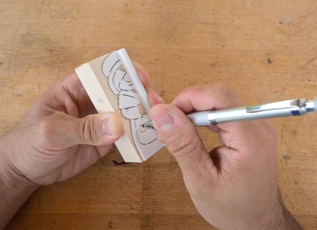 tracing a mrs claus stencil onto wood