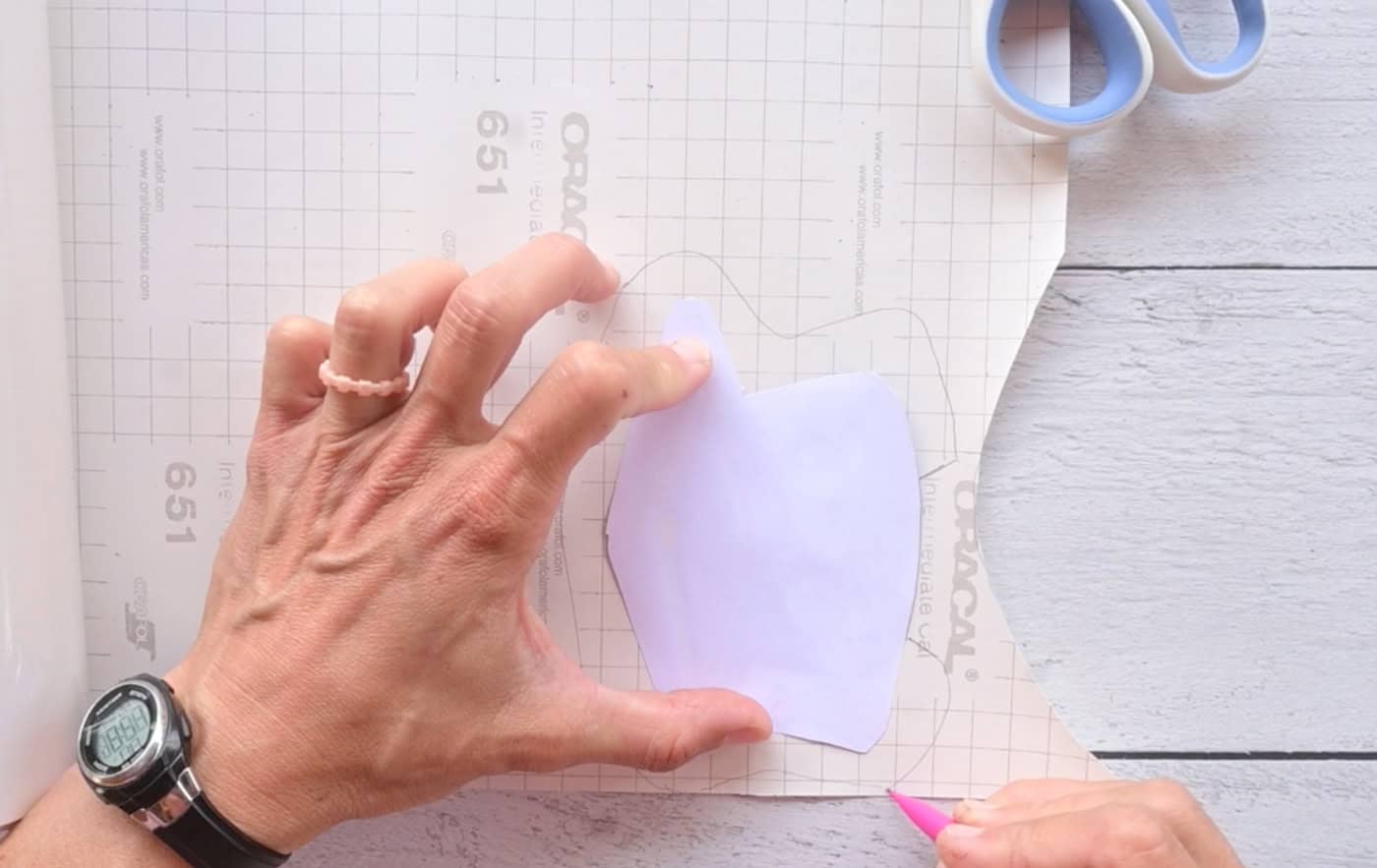 tracing a graduation cap template onto clear sticky vinyl